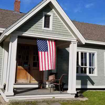 Former Edmunds-Dennysville-Marion (E.D.M.) Youth Center, now an artist's studio and gallery, decorated for Memorial Day in 2023.