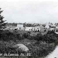          View of South Edmunds, Maine; Keith Kilby built his house on the site of the former E.I White Company store, the two story white building on the crest of the crest of the hill in the distance.
   