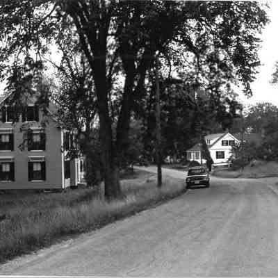The Lane in Dennysville, with the Hotel and Livery stable built by John D. Allan in 1896.: Photograph by Frank Beard for the Maine Historic Preservation Commission in 1980.