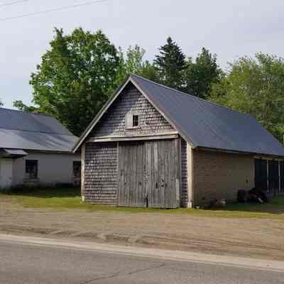 Garage and sheds next to the site of J.G. Tarbell's Hotel in Meddybemps, Maine