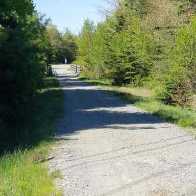 The Sunrise Trail crossing the Dennys River on the old railway trestle, seen from Route 86 in Edmunds, Maine