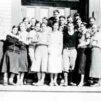          Amy Stevens Lyons and Milton Lyons Dennysville High School picture, 1934.; Amy Stevens Lyons front row second from left and Milton Lyons is front row with high laced boots.  The Congregational Meetinghouse is visible to the right, beside the schoolhouse where this picture was taken, where Milton eventually served as a faithful Deacon for many years.
   