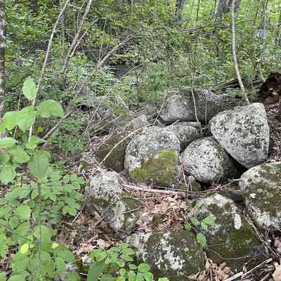 Site of the Novelty Mill on the Dennys River in Meddybemps, Maine: Located on the original site of the Baptist Church, the Novelty Mill used mostly birch to make small kitchen items. The foundation is still in evidence directly behind the church. The canal was dug to supply power to the novelty mill.