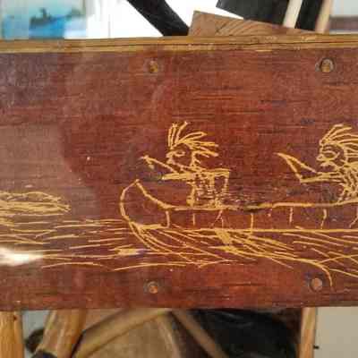 Passamaquoddy hunting scene by Tomah Jospeh: Two Passamaquoddy hunters pursuing a frightened deer into a river is etched on a birchbark seat at the Wabanaki Heritage Museum in Indian Township, Maine.  Image courtesy of Donald Soctomah.