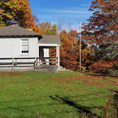 The Lincoln Memorial Library in Dennysville, Maine, as seen from King Street (Route 86).: This compact masonry and stucco building with its double columned entrance porch was a gift to the town from the Lincoln family in 1911.  It was completed in 1912 and dedicated in 1913.