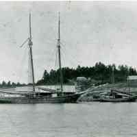          Schooner and packet at the Lincoln Wharf on the Dennys River, with Corn Hill in view.; Edmunds Lincoln's modest house and a barn are visible on Corn hill, behind the schooner and packet tied up at Lincoln's Wharf on the Dennys River in Dennysville, Maine, c. 1890.
   