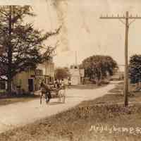          Main Street in Meddybemps; View down Main street in Meddybemps, Maine with horse and buggy, businesses and Church building in the distance, c. 1900.
   