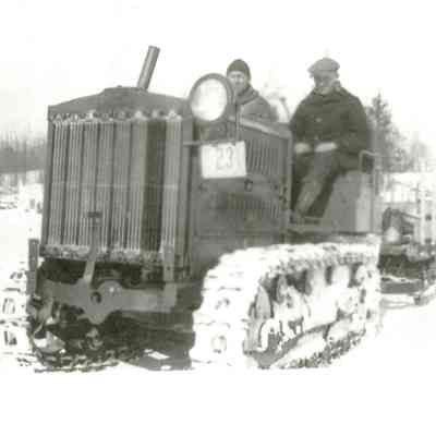Holt 5-ton tractor, driven by IrvingTyler.: The tractor, driven by Irving Tyler, was used to break the logging roads, which were sprinkled constantly by a water cart.