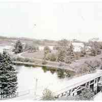         Lower Bridge across the Dennys River.; Looking across the Lower Bridge in Dennysville viewed from the belfry of the Congregational Church building.  The Aaron Hobart house is on the Edmunds shore, with T.W. Allan's wharves and warehouse around the corner.
   