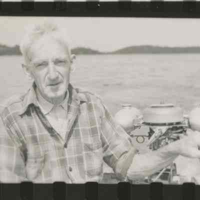 John Knapton exploring Dennys Bay in a skiff with archeologist Ted Stoddard in 1949.: Courtesy of the R.S. Peabody Museum, Andover, Massachusetts