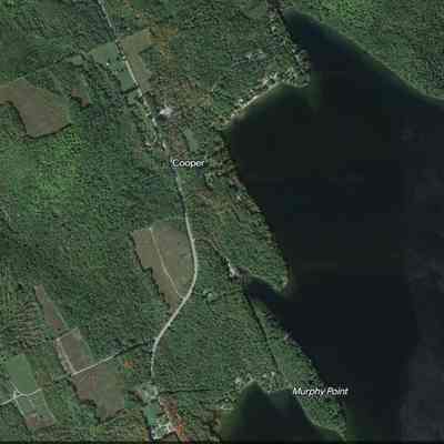 Cooper, Maine, on Google Earth: Satellite image of Murphy Point, and the site of an early schoolhouse and cemetery on the road (Rte. 191) running beside Meddybemps Lake in Cooper, Maine, accessed on Google Earth on 08-12-2023.