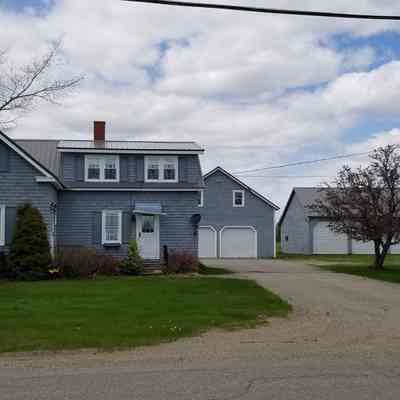 Farmhouse near Meddybemps, Maine: A neatly maintained house serves to harvest fields around Meddybemps, Maine.