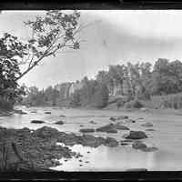          The Dennys River looking upstream; Audubon's Rock, as it is called, can be seen upstream in the river opposite Vose's store, with the tall white flagpole on the gable in this photograph by John P. Sheahan of Edmunds.
   