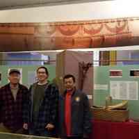          Tribal members with Passamaquoddy Canoe; Three members of the tribe pose with a life size photographic reproduction of a Passamaquoddy birchbark canoe at an exhibition at the Academy-Vestry Museum in Dennysville, Maine, during the summer of 2022.   They are, left to right: Donald Soctomah, Tribal Historic Preservation Officer, his grandson Donald Soctomah, and tribal linguist Dwayne Tomah.
   