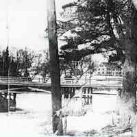          The Lower Bridge viewed from the Edmunds side with the Lincoln House in the background.; The wooden cribbing protected the rubble stone piers from scouring by the ice that rose and fell with the tide twice daily.  Photograph by Dr. John P. Sheahan of Edmunds.
   