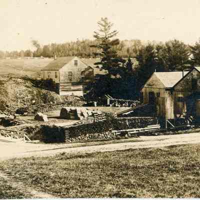 View of the Lincoln Mills on the Dennys River, 1880: Mills for long lumber, laths, staves and a machine shop on the far shore testify to the activity of the Lincoln family mills in Dennysville in this photograph by John P. Sheahan of Edmunds, Maine.