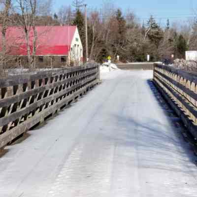 Former Railroad Trestle bridge over Dennys River, now Sunrise Trail: Dennysville ATV club is on the left beyond the end of the bridge.