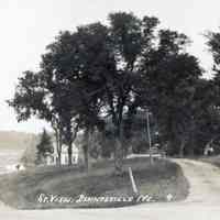          Street view of Store Hill, Dennysville, Maine, ca. 1890.; This picture was taken from the top of Store Hill (Water Street)  looking south.  The drive on the right is at the Mill House and the road on the left leads down to the Lincoln saw mills and the upper bridge and river beyond.
   