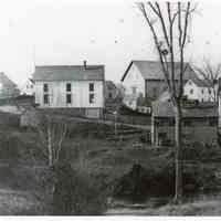          Store Hill in Dennysville c. 1897; John Allan's newly built Livery Stable dominates the skyline with T.W. Allan's Store to the left, the Riverside Inn to the right ,  and Lyman Gardner's blacksmith shop poised on the riverbank in the center.  The gable end of E.C. Wilder's old hotel, acquired by John Allan in 1865, can be seen across The Lane from the large barn.
   
