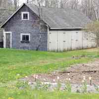          A carriage shed in Meddybemps, Maine; An old turn of the century carriage shed watches over a spiring garden off Route 191 in Meddybemps, Maine
   