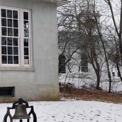 The School Bell on the Library Lawn, Dennysville, Maine: This bell once called scholars to school from its perch in the belfry above the Town Schoolhouse, which once stood between the Library and Congregational Church building seen in the background.   When the school was closed and the building razed in 1966, the bell was reinstalled in front of the Library, where it still rings.