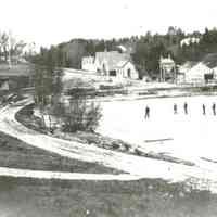          Skaters on the Dennys River Mill Pond.; Image of the Lincoln's frozen mill pond, with the mills , before 1907.  The two large buildings on the river were sold to the Dennysville Lumber Company in 1894, while the smaller buildings to the left housed the box and novelty mill, and a grist mill, both of which burned and were replaced in September of 1907.
   