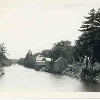 Gardner's Stores on the Dennys River: A.L.R. Gardner's blacksmith shop is closest to the camera in this view from the Lower Bridge around 1900.  It was originally built by William Kilby, who operated his blacksmith business there from the 1792 until his death in 1828.