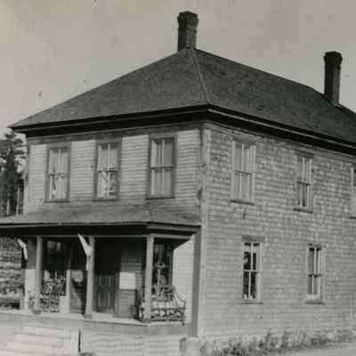 Mill Boarding house on the Bunker Hill Road, Edmunds, Maine: Note the lumber stacked to the left of the porch.  Later this served as Ken Hodgdon's Garage and subsequently as the Grange Hall.