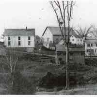          Theophilus W. Allan's Store in Dennysville, Maine,; View of T.W. Allan's store, on the left, with the John K. Allan's high roofed livery stable, Lyman K Gardner's blacksmith shop and the Riverside Inn, viewed from across the river in Edmunds prior to 1893.Lyman K. GR
   