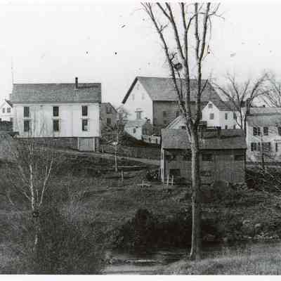 Theophilus W. Allan's Store in Dennysville, Maine,: View of T.W. Allan's store, on the left, with the John K. Allan's high roofed livery stable, Lyman K Gardner's blacksmith shop and the Riverside Inn, viewed from across the river in Edmunds prior to 1893.Lyman K. GR