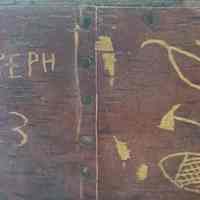          Tomah Joseph's signature, 1913; One time tribal Governor and birchbark artist Tomah Joseph recorded his name and distinctive Passamaquoddy tools on this decorative seat in 1913.  Image courtesy of Donald Soctomah from the Wabanaki Heritage Museum in Indian Township, Maine.
   