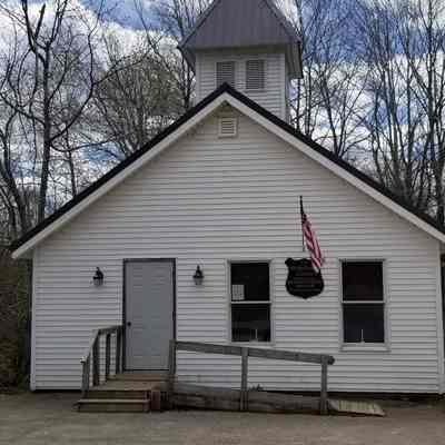 Meddybemps Church building, Meddybemps, Maine, 2023: Image of the Meddybemps meetinghouse showing an addition to the front of the building, and other alterations.