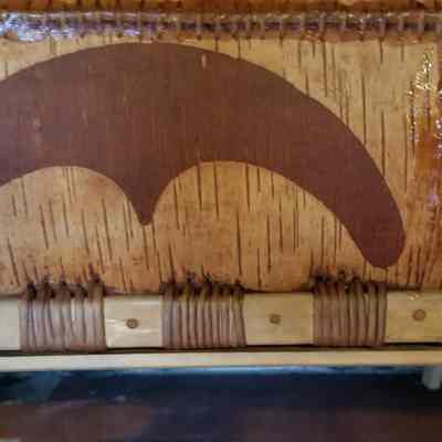 Traditional design on Passamaquoddy Canoe: Detail of the gunwale and patters inscribed on the mid section of a birchbark canoe at the Wabanaki Museum in Indian Township, Maine.
