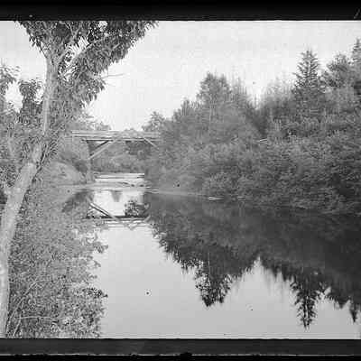 Falls Bridge over the Dennys River, c. 1885: Late nineteenth century view of the wooden structure of Falls Bridge looking downstream along the Denny River.  Photograph by Dr. John P. Sheahan of Edmunds.