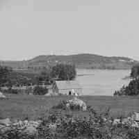          Clark Point at the Dennys River Narrows; Cleared fields and blueberry land cover Clark Point in this view across the Dennys River from the 1880's. The cottage built by John Matthie, an immigrant from Scotland, is in the foreground of this photograph by Dr.John P. Sheahan of Edmunds.
   