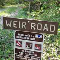          Weir Road trailhead in the Moosehorn Wildlife Refuge, Edmunds, Maine; Trailhead signage for the Weir Road on U.S. Route 1 denotes the point of access to the Weir Road as it follows Hobart Stream through the Moosehorn National Wildlife Refuge in Edmunds, Maine.
   