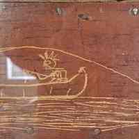          Sport with a Passamaquoddy Guide, Tomah Joseph, c. 1910.; The thrill of the catch is captured in Tomah Joseph's etching of a sport fisherman hooking a salmon and losing his hat on this birchbark panel at the Passamaquoddy Heritage Museum in Indian Township, Maine.  Image courtesy of Donald Soctomah and the Tribal Historic Preservation Office.
   