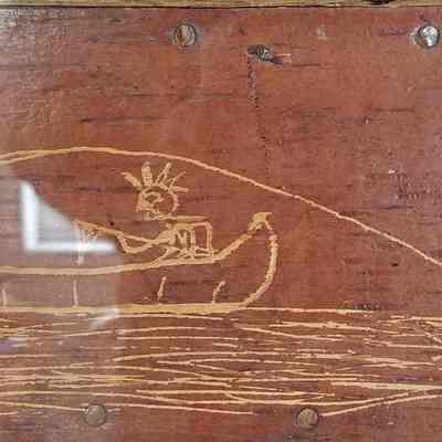 Sport with a Passamaquoddy Guide, Tomah Joseph, c. 1910.: The thrill of the catch is captured in Tomah Joseph's etching of a sport fisherman hooking a salmon and losing his hat on this birchbark panel at the Passamaquoddy Heritage Museum in Indian Township, Maine.  Image courtesy of Donald Soctomah and the Tribal Historic Preservation Office.