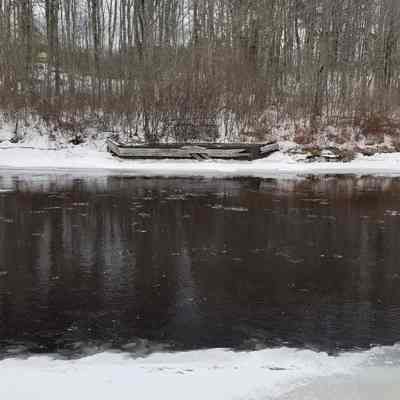 Dennys River Salmon Weir Abutment: The wooden abutment on the Edmunds side of the river marks the location of stainless steel salmon weir installed seasonally by the Maine Department of Inland Fisheries and Wildlife to capture and count adult salmon returning to the Dennys River to spawn, beginning around 2010.