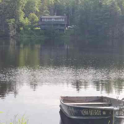 Freshwater Pond at Robinson's Cottages: A row boat rides lazily on the calm waters of the pond at Robinson's Cottages in Edmunds, Maine.