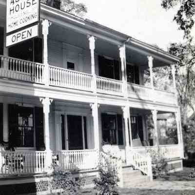 The Allan House, operating also under the name of the Riverside Inn or Hotel, in Dennysville, Maine.: A full two story veranda at one time graced the front of the Allan House, a.k.a. the Riverside Inn, eventually  replaced with single story awning.  the sing advertises the establishments well know reputation for good food and lodging.