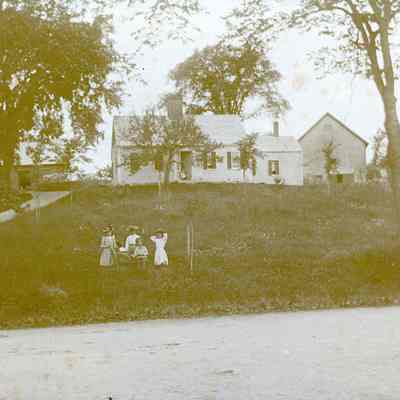 Fred L. Gardner House, Dennysville, Maine, c.: Gardner children Louis, Leigh, Julia and Edith, with their grandmother Mary, and Aunt Eva behind, in front of their family home, viewed from Water Street.