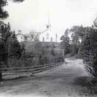          View of Lower Bridge Between Edmunds and Dennysville, c. 1910; The Congregational Meetinghouse and schoolhouse in Dennysville are seen above the Lower Bridge on Meetinghouse Hill
   
