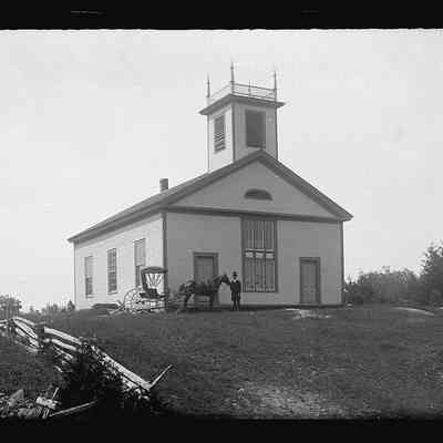 Edmunds Methodist Church building with Dr. John P. Sheahan, photographer: Photograph of Dr. John P. Sheahan with his horse and buggy standing in front of the Methodist Episcopal Church building on the Preston (now River) Road in Edmunds.  Photograph by Dr. John Parris Sheahan, c. 1885.