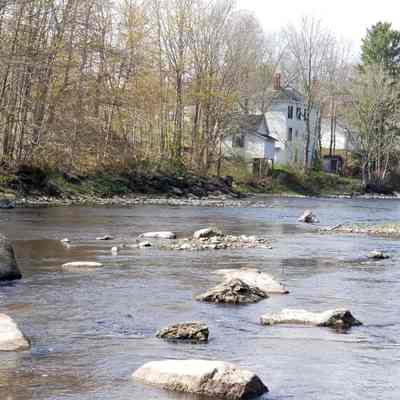 View of Allan-Burns-Mattheson house from the Dennys River: The view of the Mattheson House as seen from the Dennys river, with Audubon's Rock on the left, and the Post Office in the distance on the right.