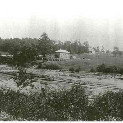 Lumber Company buildings and houses on Bunker Hill, Edmunds, Maine, c. 1910: Noah Sylvia's compact house appears on the crest of the hill opposite Stephen Lyons' house and barn.